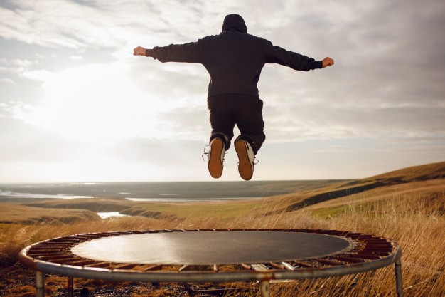 Young man jumping on a trampoline Premium Photo