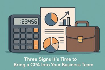 Business owner reviewing financial documents with CPA, highlighting signs to hire accounting expert